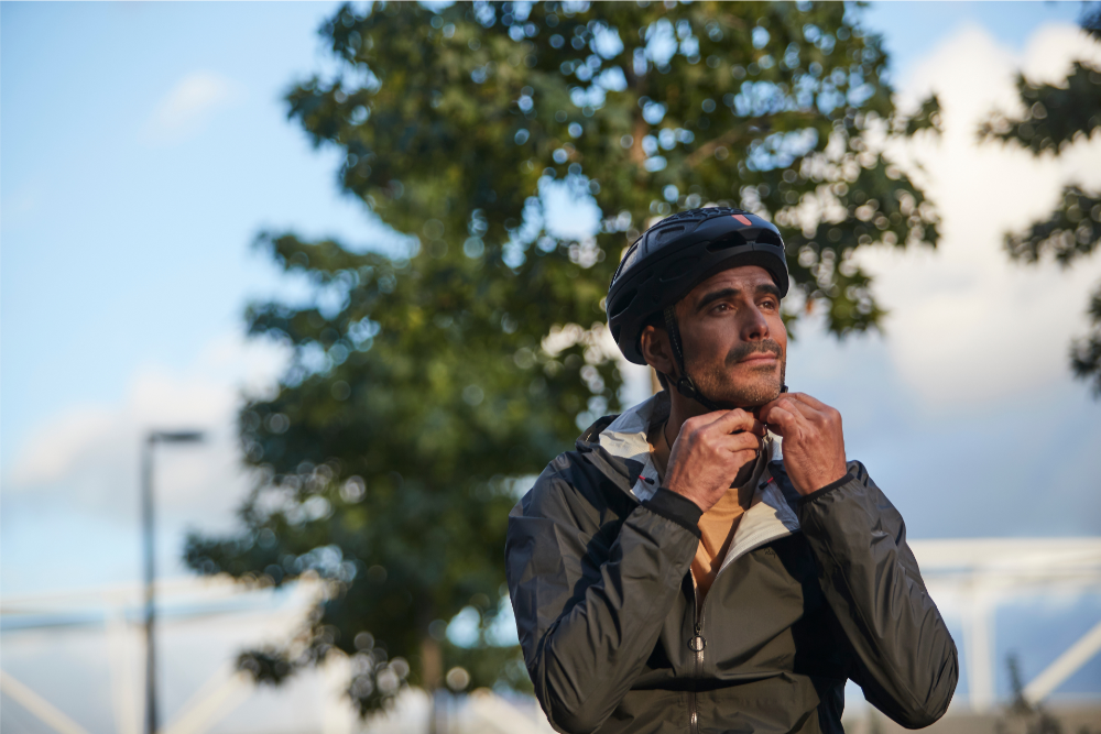 close up of man wearing foldable bike helmet