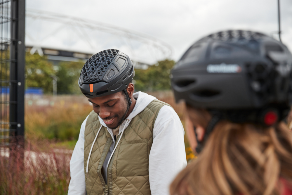 man and woman wearing packable bike helmets